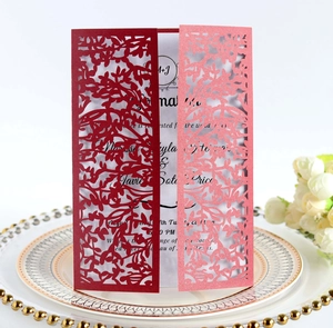 Detailed laser-cut hollow floral wedding invitation card on a decorative porcelain plate