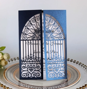 Detail of laser-cut navy blue European wedding invitation with elegant hollow patterns