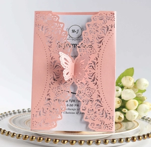 Detail of laser-cut pink invitation card with 3D butterfly and elegant floral pattern