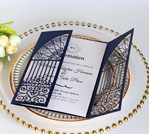 Macro detail of navy blue laser-cut wedding invitation featuring intricate hollow patterns