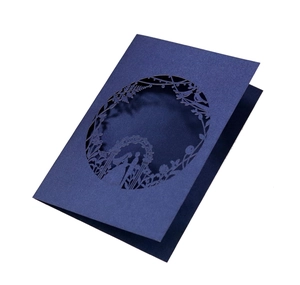 Detail of laser cut navy blue wedding invitation card with floral and bride groom silhouette