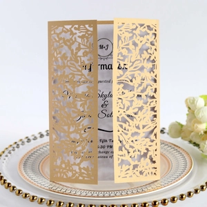 Elegant champagne gold laser cut wedding invitation with intricate leaf pattern design