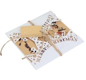 Close-up of laser-cut snowflake Christmas card with kraft insert and hemp rope bow