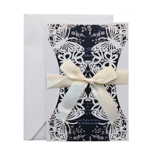 Elegant laser cut wedding invitation with white bow and navy floral inner card