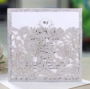 Silver laser cut wedding invitations with glitter flower patterns and insert cards