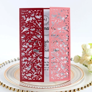 Elegant laser-cut leaf design wedding invitation cards in deep red and pink finishes