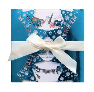 Laser-cut Merry Christmas invitation in reflective blue metallic card with white ribbon