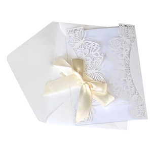 Laser-cut white butterfly wedding invitation set with an elegant satin ribbon and envelope
