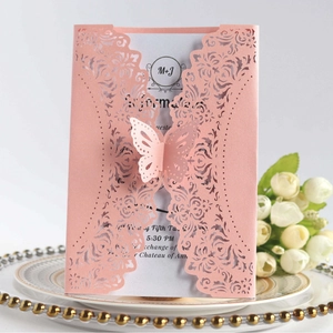 Pink laser-cut wedding invitation with butterfly design and elegant floral patterns