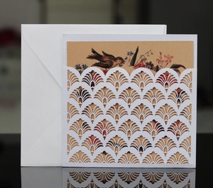 Laser cut lace wedding invitation with white fan shell and kraft paper insert