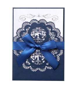 Elegant navy blue laser cut wedding invitation with white insert and satin ribbon bow