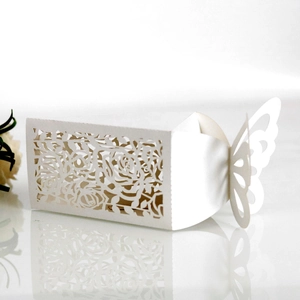 Detailed laser-cut rose patterns on white wedding candy box with butterfly closure
