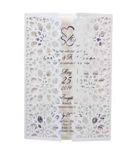 Detail of laser-cut wedding invitation with intricate floral mandala patterns