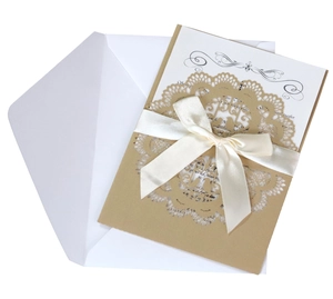 Laser cut lace wedding invitation with kraft paper cover and white ribbon bow detail