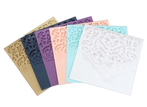 Macro view of laser-cut wedding invitation envelopes in various elegant colors