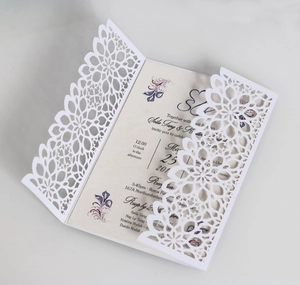 Detail view of laser-cut floral wedding invitation with cream insert and elegant lettering