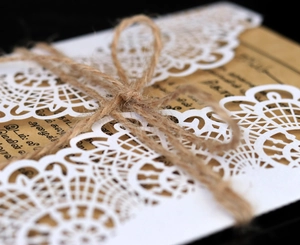 Laser cut wedding invitation with white hollow sleeve, kraft paper and hemp twine bow