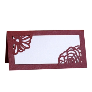 Laser cut burgundy wedding place card with elegant floral hollow pattern and glitter finish