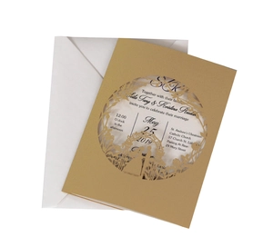 Macro view of laser-cut wedding invitation with intricate floral patterns and silhouettes