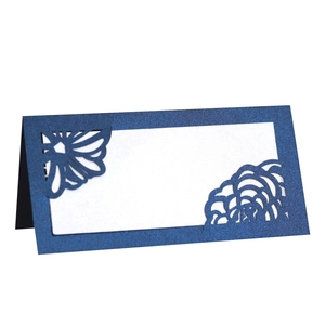 Detail of laser-cut navy blue pearl paper place card with floral hollow-out design
