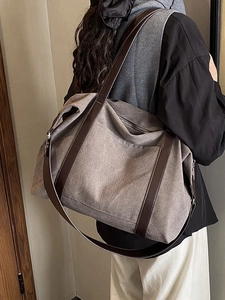 Large retro canvas tote bag with brown leather straps shown on model for daily commuting