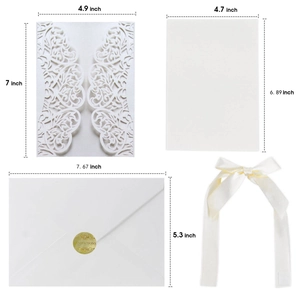 Elegant white laser-cut floral wedding invitation set with envelopes and ribbon