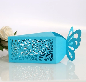 Macro detail of sky blue laser-cut candy box with rose patterns and butterfly top