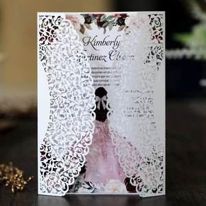 Detailed macro view of laser-cut lace texture on elegant white wedding invitation