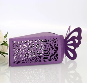 Macro shot of purple laser-cut rose patterns on a butterfly-shaped gift box