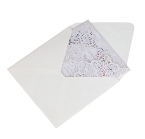 Detailed laser-cut white wedding invitation card with elegant lace pattern and envelope