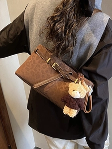Retro leopard print bucket bag with brown leather strap and teddy bear charm