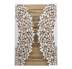 Detail of laser-cut leaf pattern invitation with kraft paper card and Tamil print