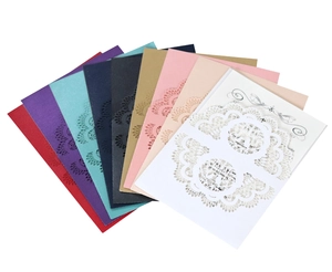 Detailed laser-cut lace pattern on multicolored paper wedding invitations with inner card