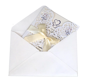 Elegant white laser-cut heart invitation cards with cream ribbon and envelopes set