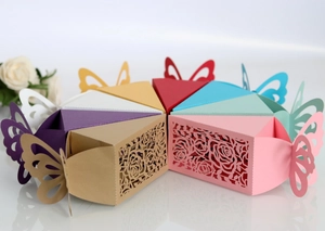 Detailed laser-cut rose patterns on colorful triangle cake-shaped paper favor boxes