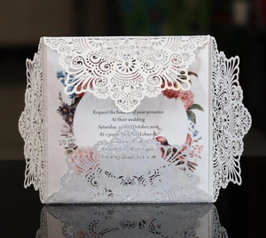 White laser-cut floral wedding invitation set with elegant colorful floral insert card