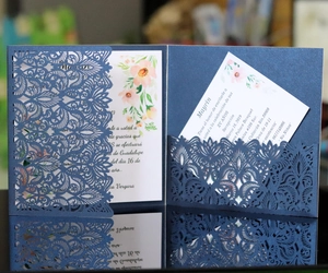 Laser cut dark blue wedding invitation with lace pattern and floral inner card