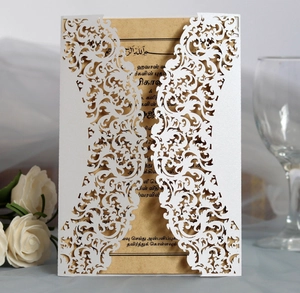 Detailed laser-cut white lace invitation card with kraft paper insert and elegant roses