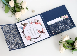 Navy blue laser cut wedding invitation set with floral inner card and RSVP card on white background