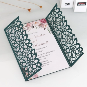 Detail of dark green laser cut wedding invitation with floral insert and tri-fold design