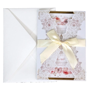 Elegant white laser-cut wedding invitation with champagne ribbon and floral inner card