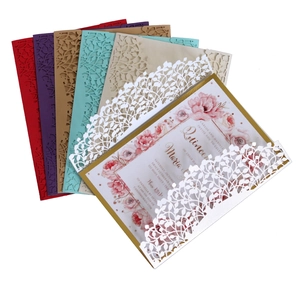 Detailed macro view of laser-cut leaf pattern invitations in various elegant colors