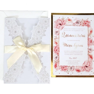 Elegant white laser-cut wedding invitation set with lace pattern and ribbon bow