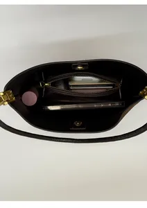 Detail view of the interior compartments and magnetic closure of the leather hobo bag