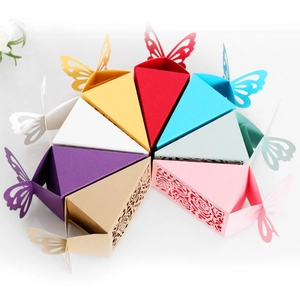 Laser-cut butterfly wedding favor boxes in assorted colors arranged in a circle