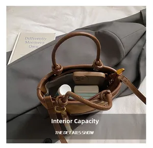 Internal capacity of retro patchwork bucket bag showing phone and cosmetics inside