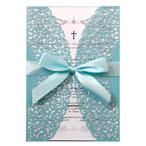 Elegant laser cut blue wedding invitation with floral pattern and satin ribbon bow