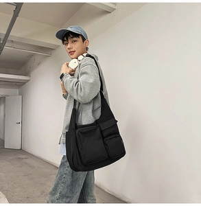 Detail of urban techwear crossbody bag with multiple functional pockets and canvas texture