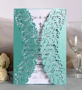 Elegant mint green laser-cut wedding invitation with white lace pattern and inner card
