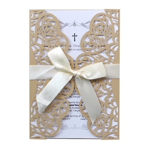 Laser cut white wedding invitation with golden butterfly cover and elegant cream ribbon bow